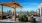 a patio with chairs and tables and a view of a city