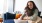 a woman and a man looking at a laptop