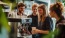 a group of people standing around a coffee machine